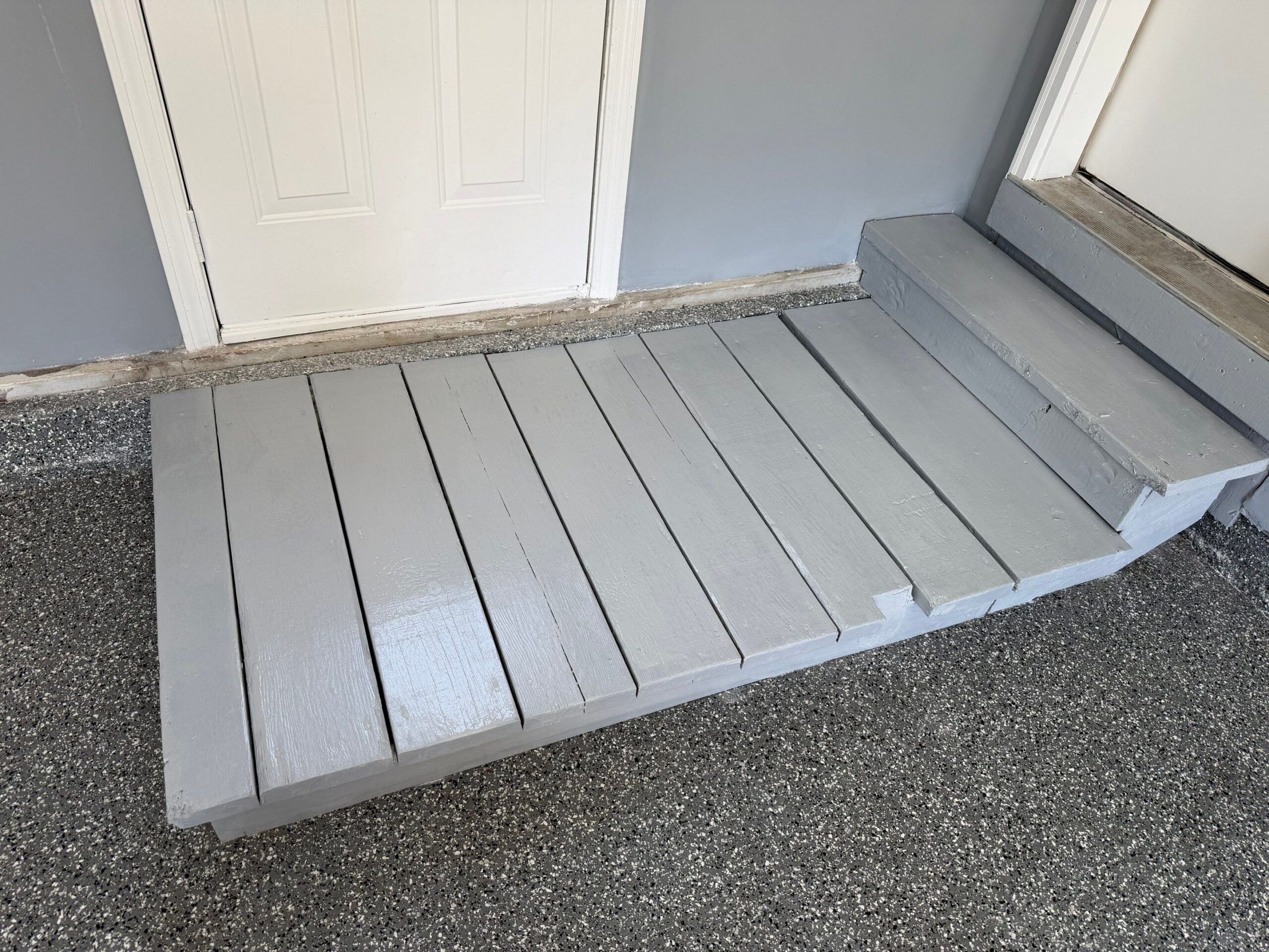 Painted outdoor wooden steps and entryway door